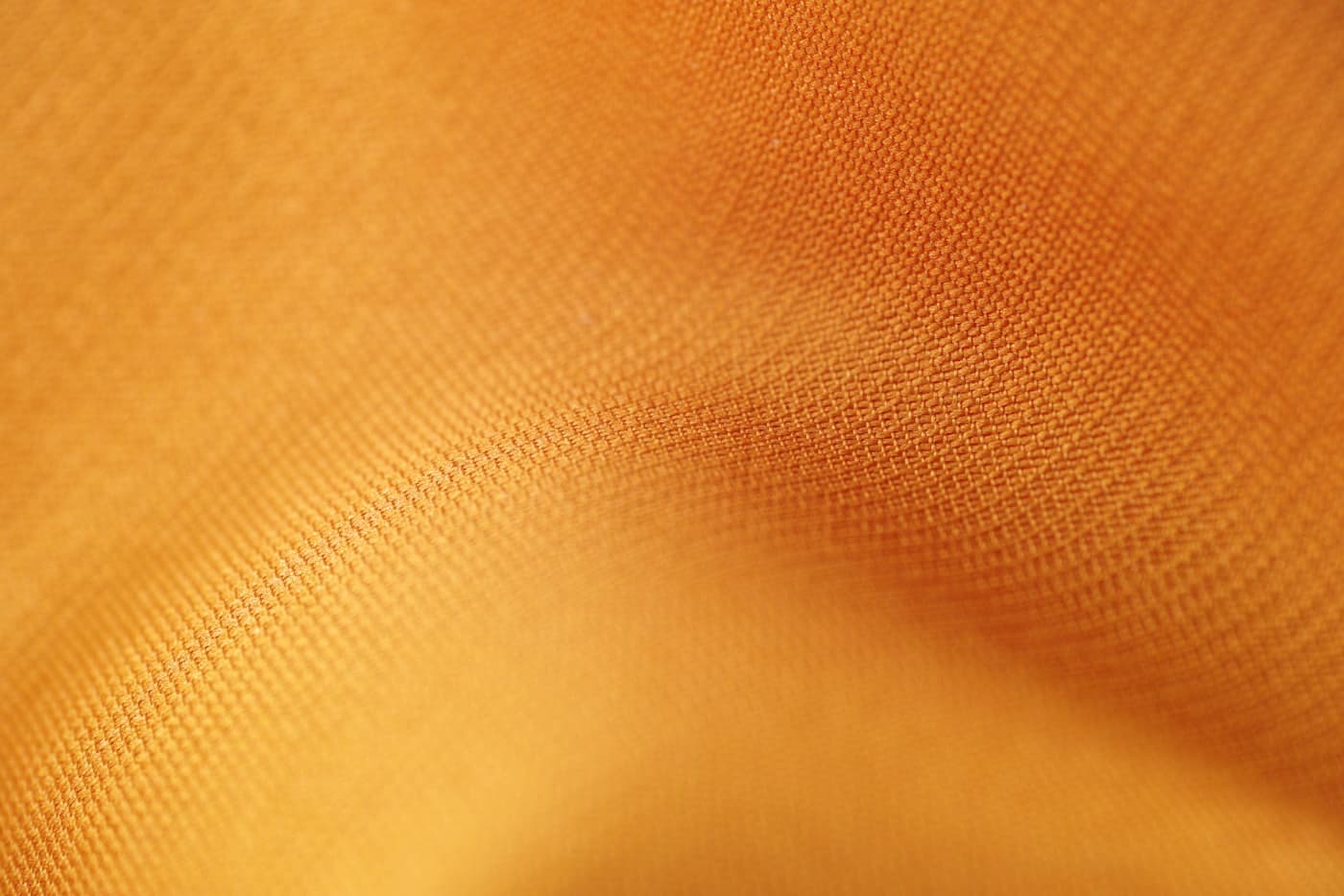 Close-up of fine amber satin fabric